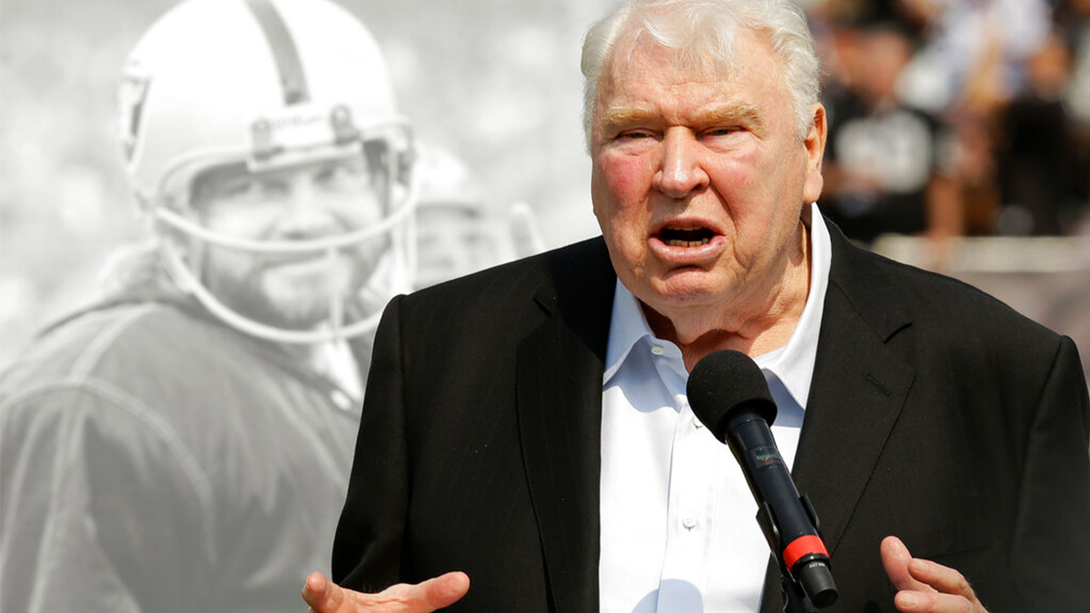 Former Oakland Raiders head coach John Madden speaks about former quarterback Ken Stabler, pictured at rear, at a ceremony honoring Stabler during halftime of an NFL football game between the Raiders and the Cincinnati Bengals in Oakland, California, on Sept. 13, 2015. 