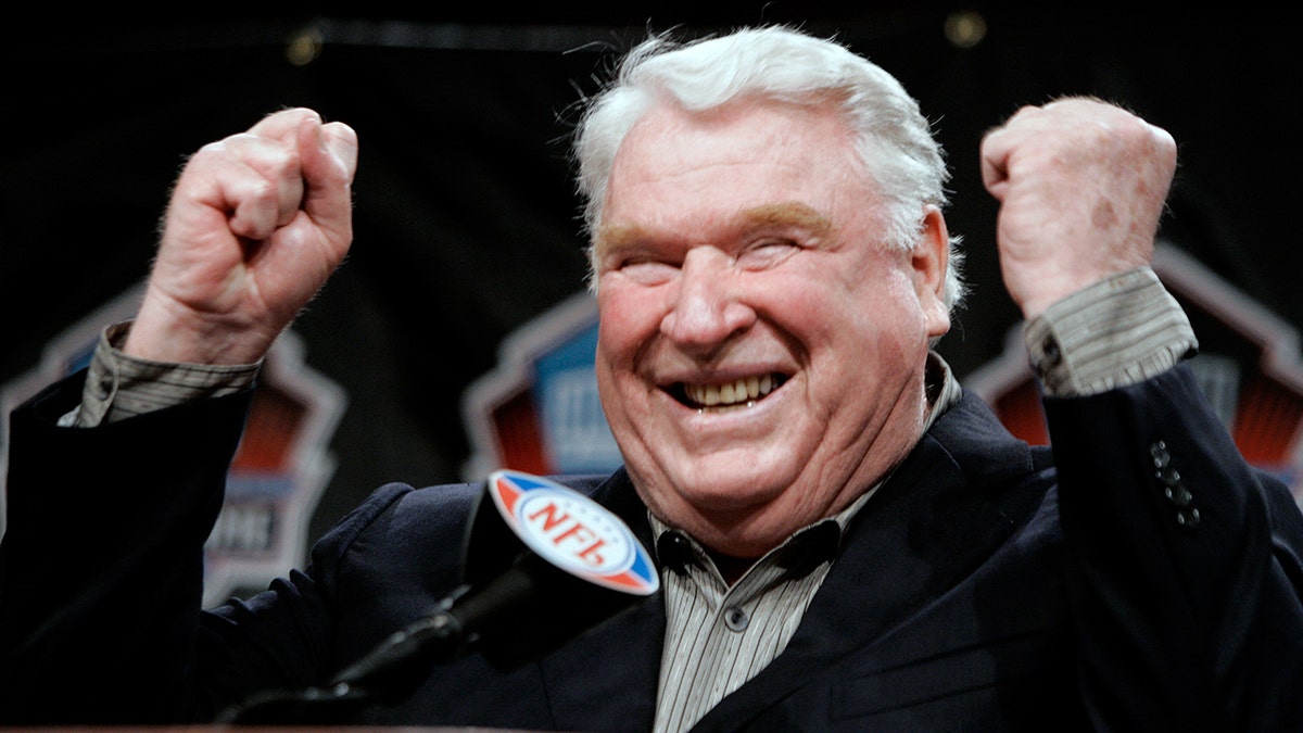 John Madden, former coach of the Oakland Raiders, celebrates after being named into the NFL Hall of Fame at a news conference in Detroit, Michigan, Feb. 4, 2006. 