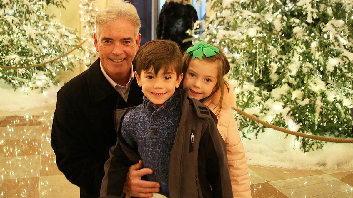 John Roberts with his young twins, Kellan and Sage, at the White House one Christmas