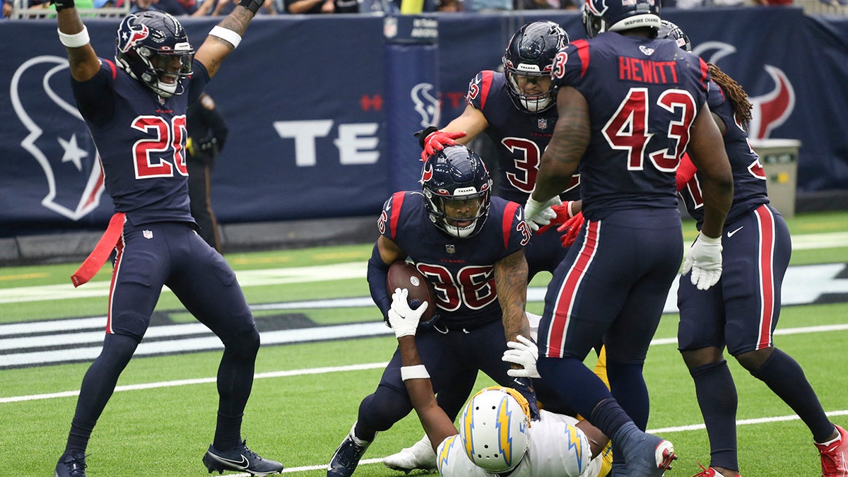 Dec 26, 2021; Houston, Texas, USA; Houston Texans defensive back Jonathan Owens (36) intercepts the ball against Los Angeles Chargers wide receiver Josh Palmer (5) in the second quarter at NRG Stadium.