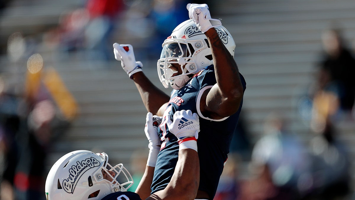 Fresno State running back Jordan Mims, right, celebrates with teammate Juan Rodriguez (80) after scoring a touchdown against UTEP during the first half of the New Mexico Bowl NCAA college football game Saturday, Dec. 18, 2021, in Albuquerque, N.M.