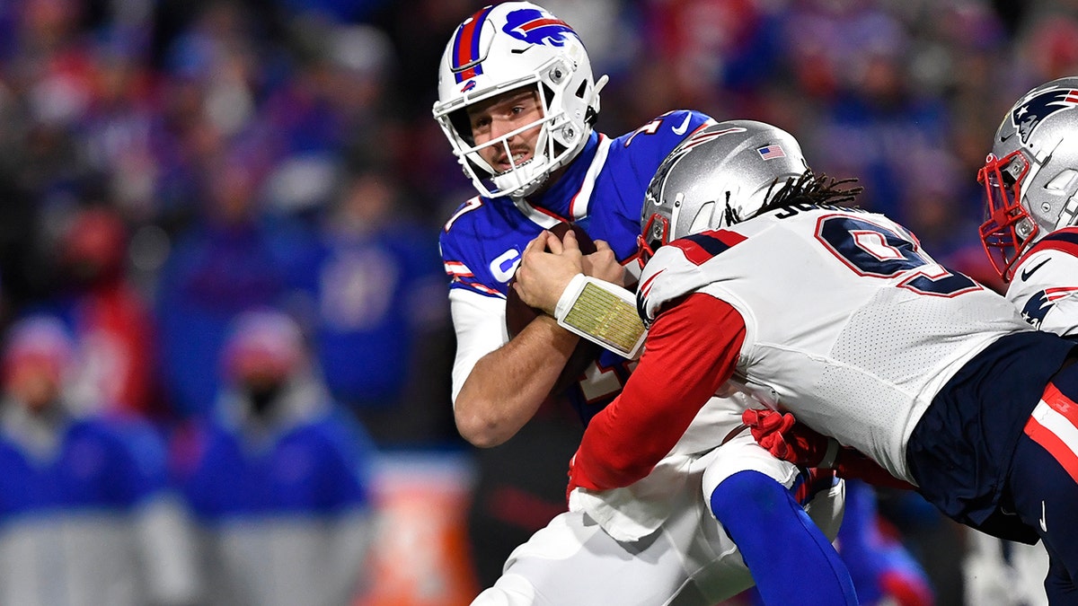 Buffalo Bills quarterback Josh Allen is tackled by New England Patriots outside linebacker Matt Judon