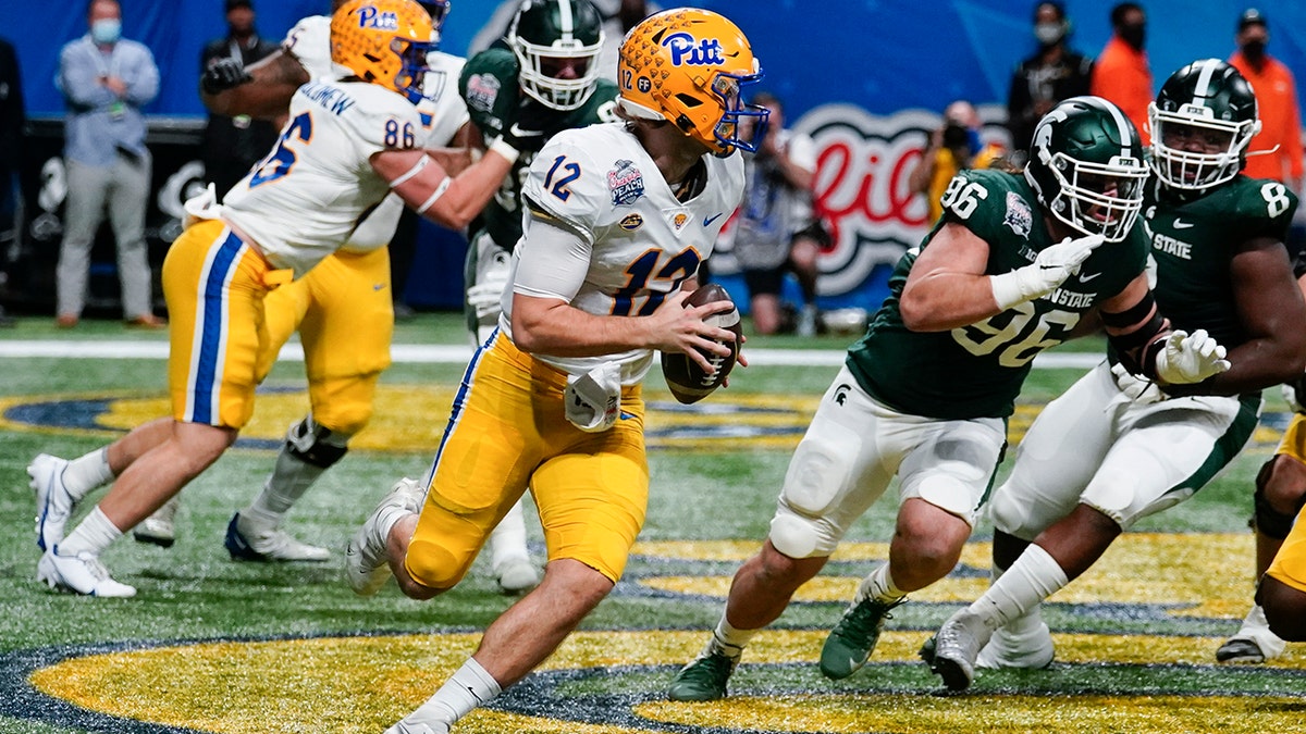 Pittsburgh quarterback Nick Patti (12) scrambles in the end zone against Michigan State during the first half of the Peach Bowl NCAA college football game, Thursday, Dec. 30, 2021, in Atlanta.