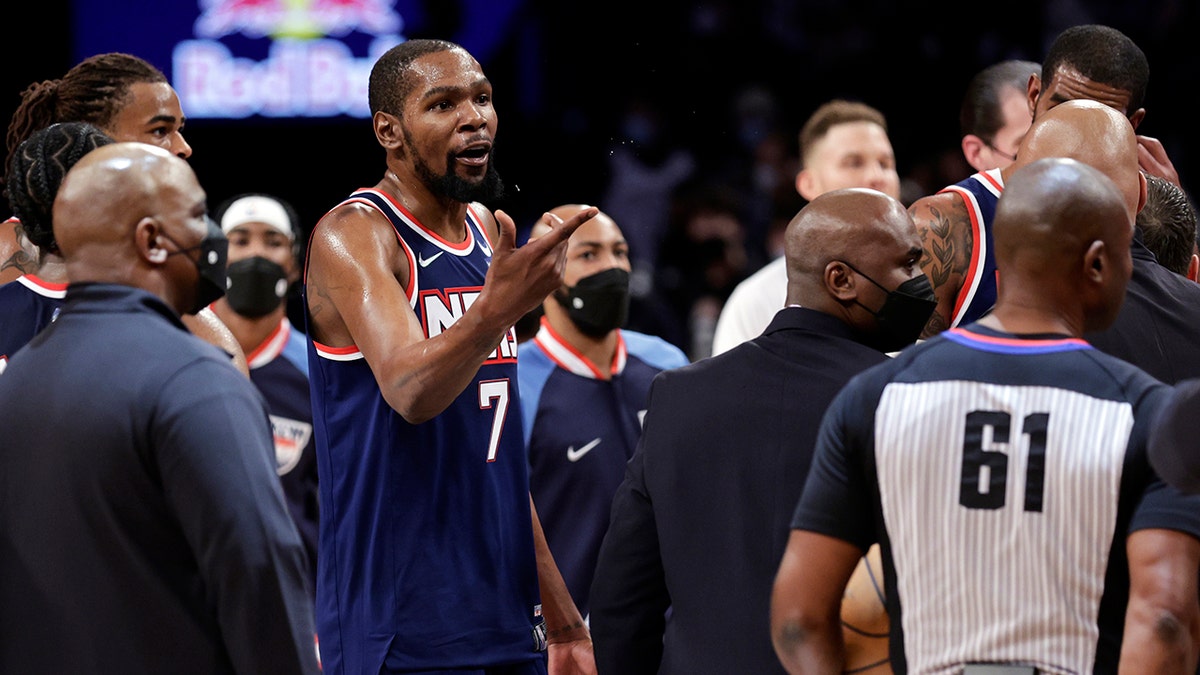 Brooklyn Nets forward Kevin Durant (7) gestures toward Philadelphia 76ers center Joel Embiid after an NBA basketball game Thursday, Dec. 30, 2021, in New York.
