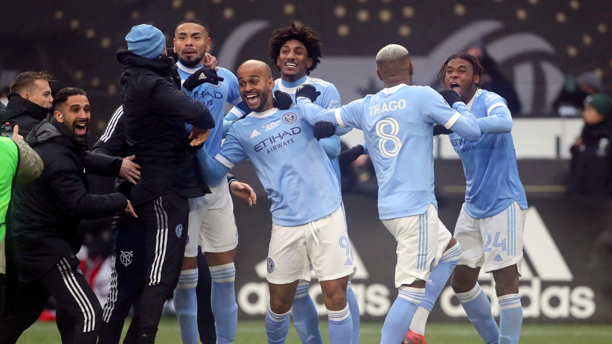 New York City FC players celebrate their penalty kick shootout win over the Portland Timbers in the MLS Cup soccer game, Saturday, Dec. 11, 2021, in Portland, Ore. (AP Photo/Amanda Loman)