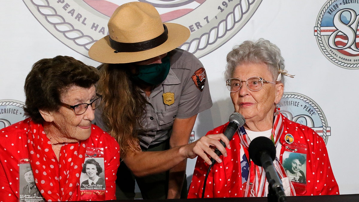 Mae Krier, right, who worked at a Boeing plant during World War II making B-17s and B-29s, speaks at a news conference in Pearl Harbor, Hawaii on Sunday, Dec. 5, 2021 accompanied by Marian Wynn, left, who worked as a pipe welder during the war. 