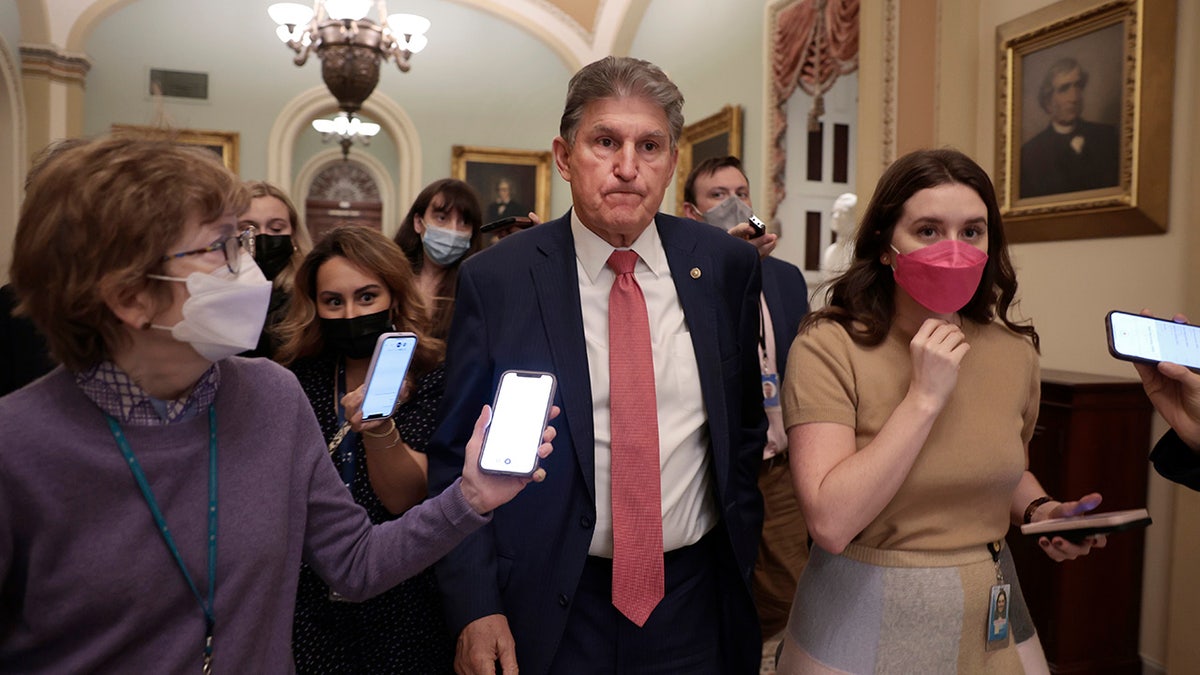 Sen. Joe Manchin, D-W.Va., is followed by reporters as he leaves a caucus meeting with Senate Democrats at the U.S. Capitol Building on Dec. 17, 2021, in Washington, D.C. 