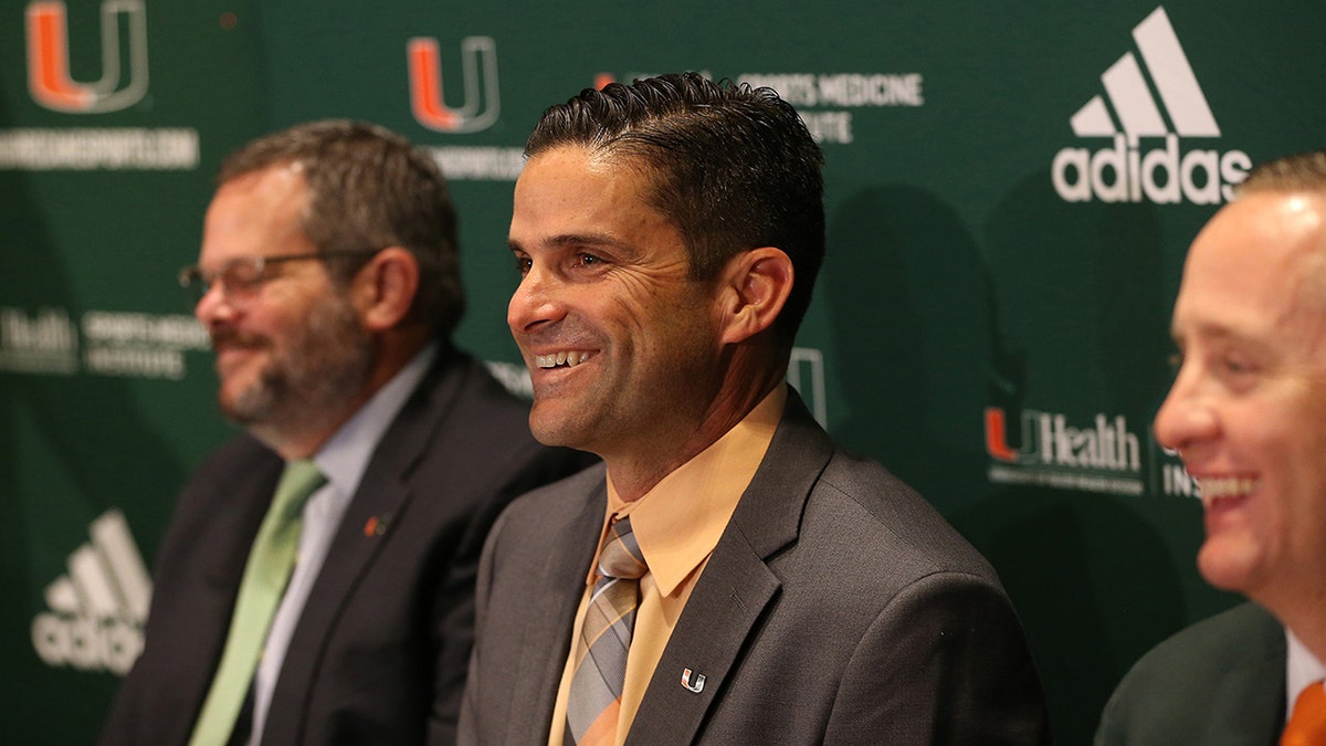 Sitting between David Epstein (left), Board of Trustees and Athletic Director Blake James, Manny Diaz (center) gets introduced as the University of Miami's 25th head football coach in program history on Wednesday January 2, 2019.