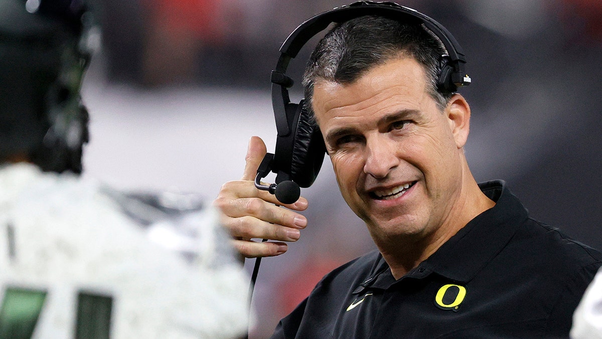 Head coach Mario Cristobal of the Oregon Ducks talks to his players during a timeout in the Pac-12 Conference championship game against the Utah Utes at Allegiant Stadium December 3, 2021 in Las Vegas. The Utes defeated the Ducks 38-10. 