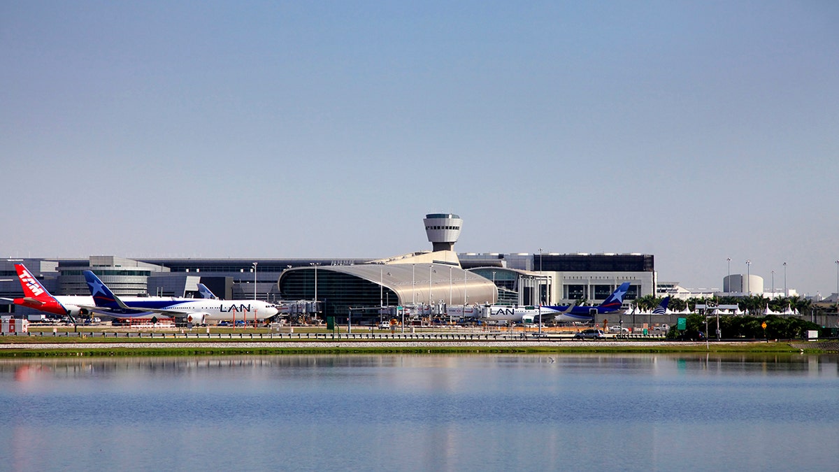 Miami, Florida, USA - May 9, 2013: Panoramic photo of the famous Miami International Airport with lots of airplanes loading and unloading passenger and cargo on May 9, 2013 in Miami, Florida, USA.