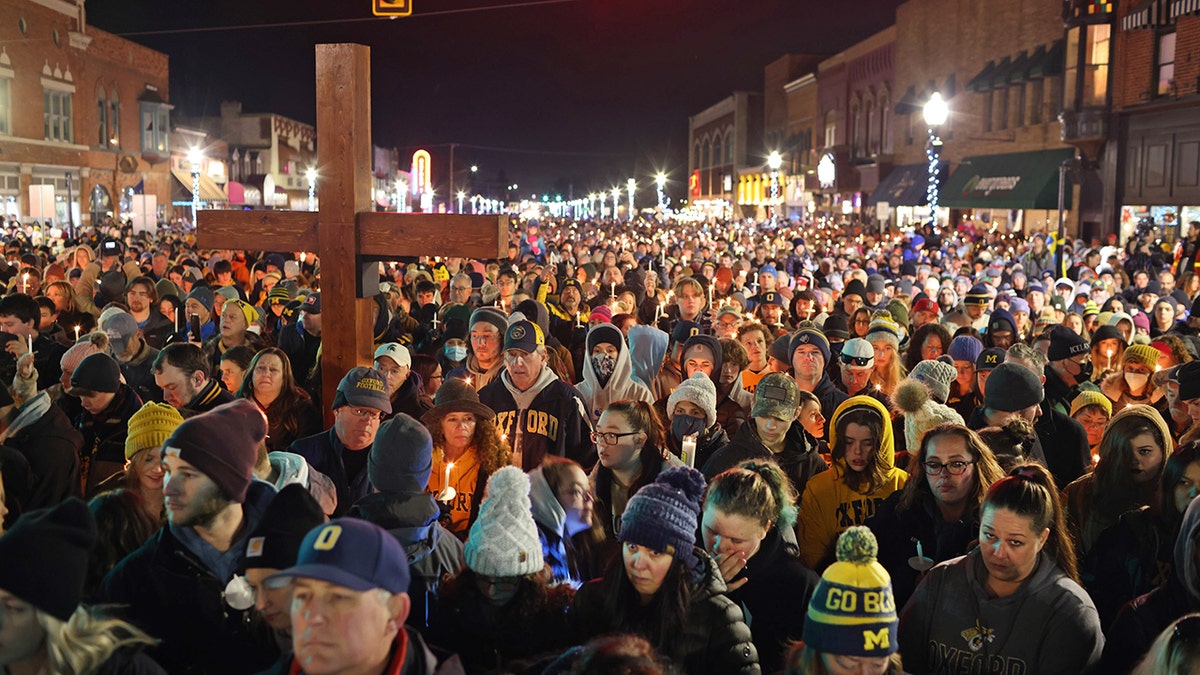 OXFORD, MICHIGAN - DECEMBER 03: People attend a vigil downtown to honor those killed and wounded during the recent shooting at Oxford High School on December 03, 2021 in Oxford, Michigan. Four students were killed and seven others injured on November 30, when student Ethan Crumbley allegedly opened fire with a pistol at the school. Crumbley has been charged in the shooting. Today his parents were also charged. (Photo by Scott Olson/Getty Images)