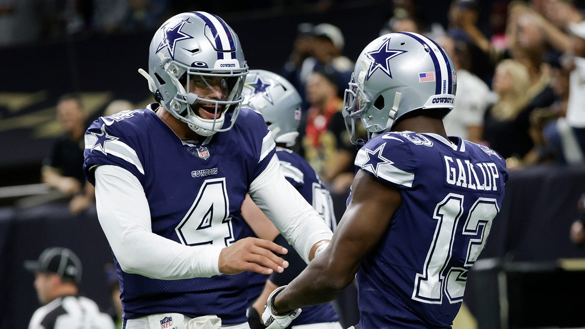 Dallas Cowboys quarterback Dak Prescott (4) celebrates the touchdown by Dallas Cowboys wide receiver Michael Gallup (13) during the first half of an NFL football game against the New Orleans Saints, Thursday, Dec. 2, 2021, in New Orleans.
