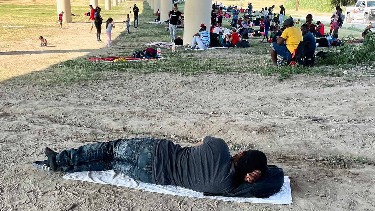 Migrants under a bridge at the Rio Grande near the Del Rio-Acuna Port of Entry in Del Rio, Texas.