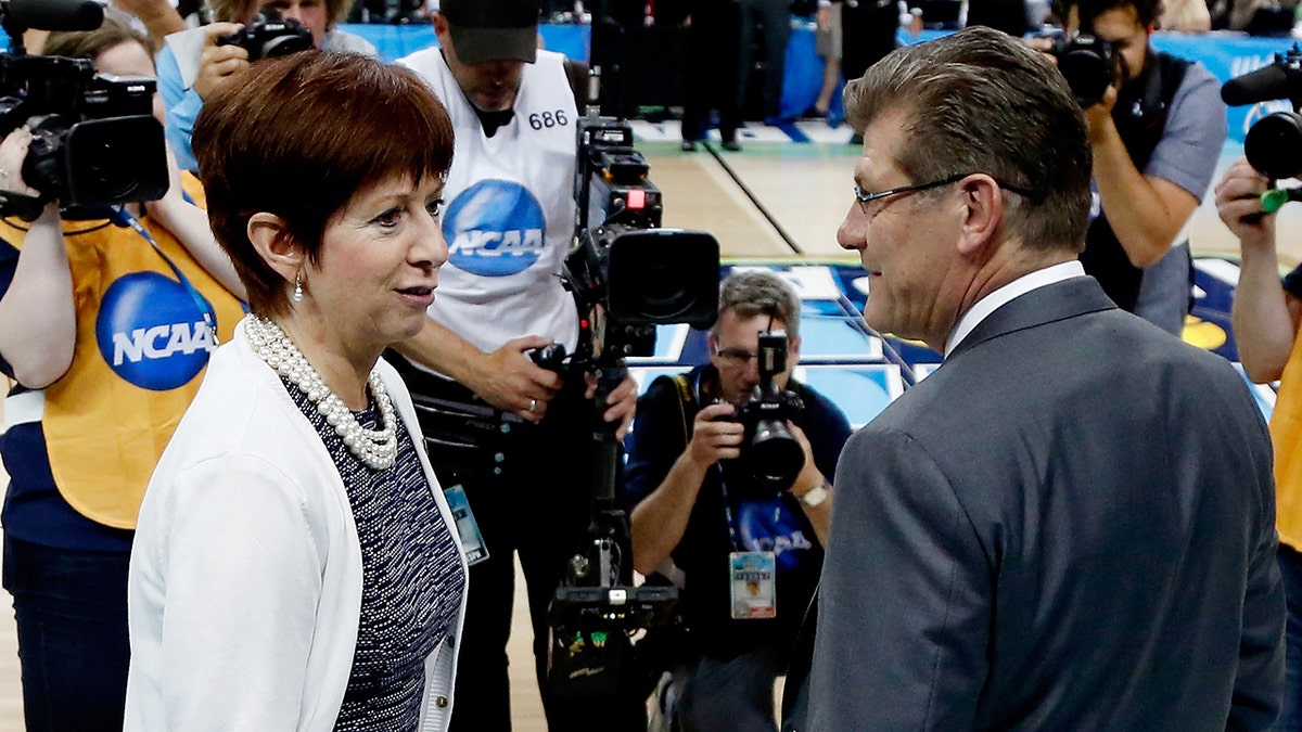 TAMPA, FL - APRIL 07: Head coach Muffet McGraw of the Notre Dame Fighting Irish (L) and head coach Geno Auriemma of the Connecticut Huskies meet prior to the start of the NCAA Women's Final Four National Championship at Amalie Arena on April 7, 2015 in Tampa, Florida. 