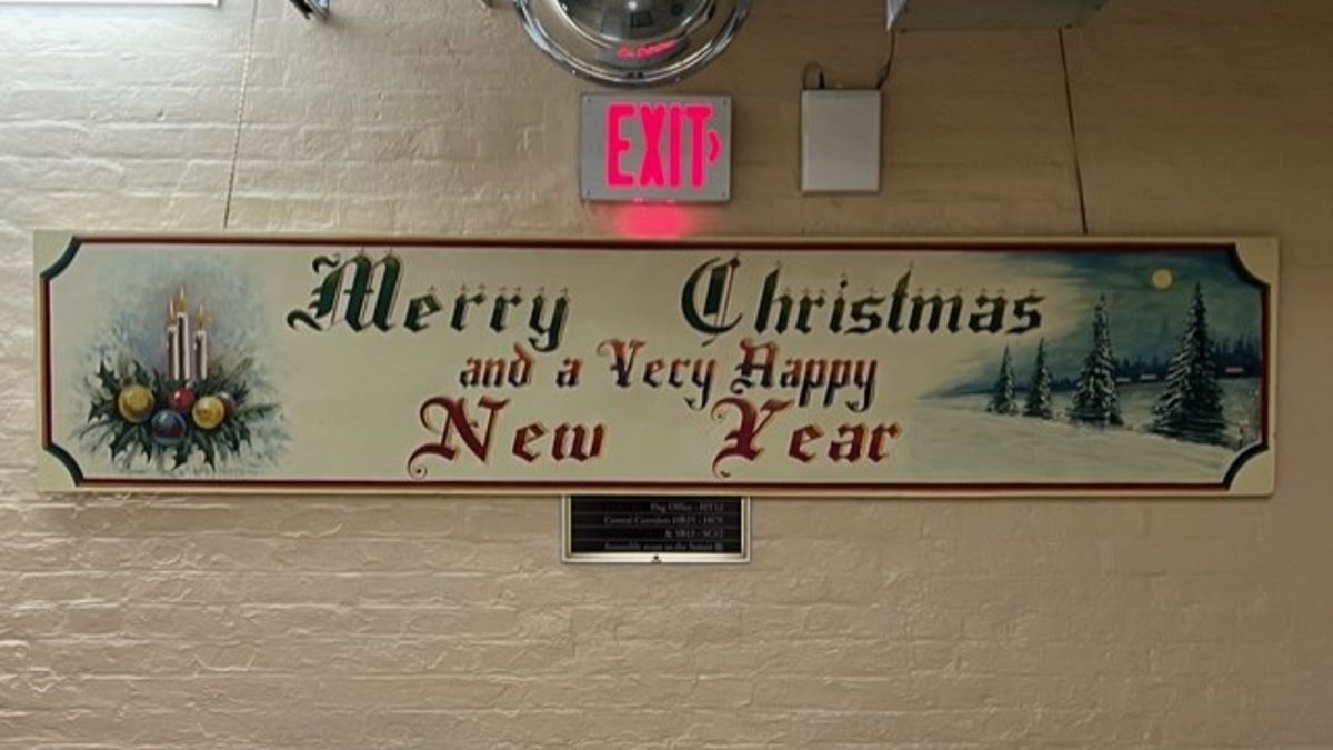 Every year a beautiful mural emerges in an obscure, basement hallway of the Capitol. "Merry Christmas," declares the long, wooden mural in evergreen paint and an Olde English font. "And a very happy New Year." 