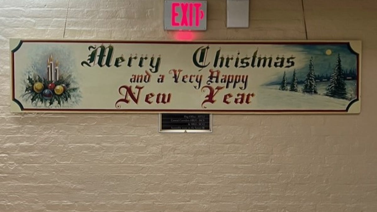Every year a beautiful mural emerges in an obscure, basement hallway of the Capitol. "Merry Christmas," declares the long, wooden mural in evergreen paint and an Olde English font. "And a very happy New Year."