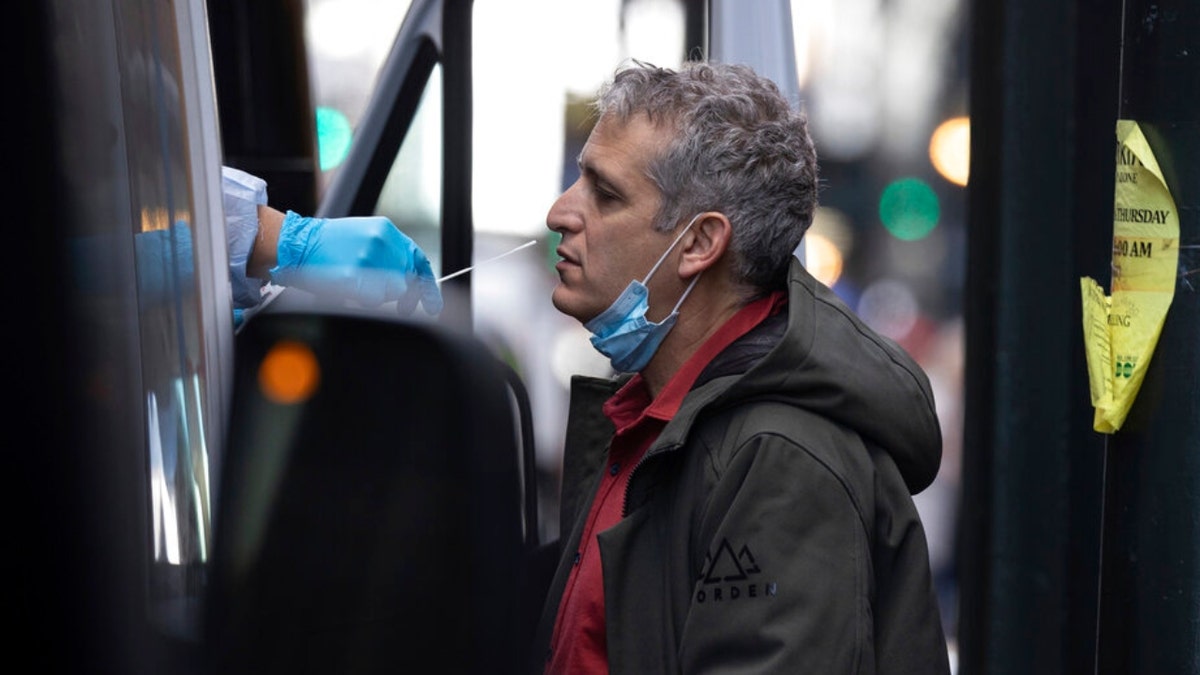 A person takes COVID-19 test at mobile testing site near Grand Central Terminal