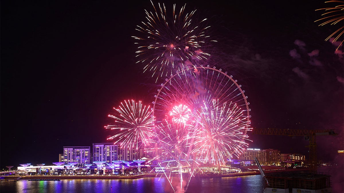 A picture taken on December 31, 2021 shows fireworks erupting in front of Ain Dubai.