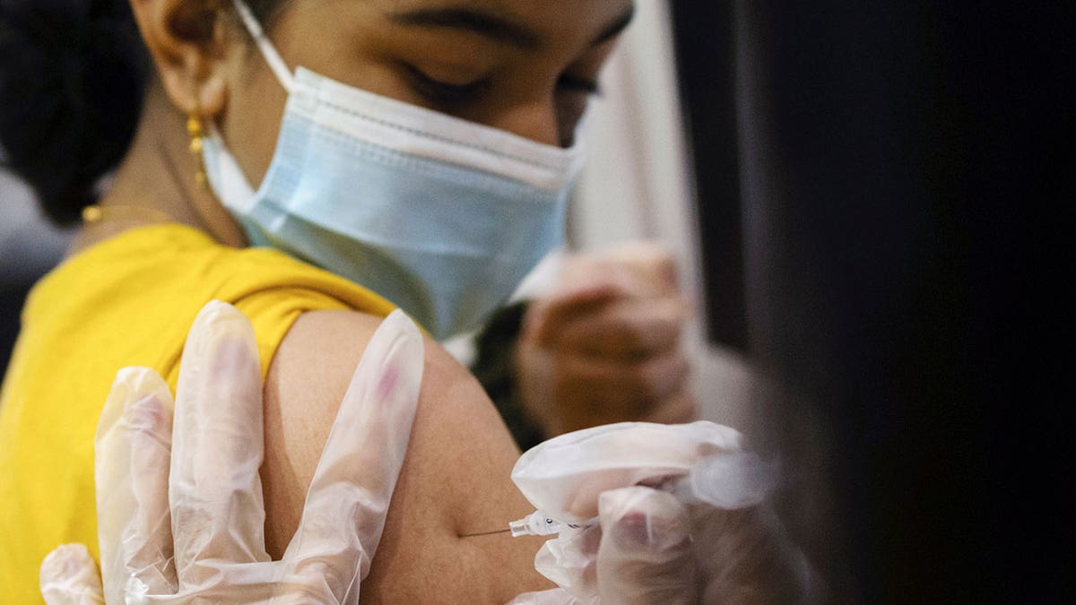 A girl receives the Pfizer-BioNTech coronavirus disease (COVID-19) vaccine in Lansdale, Pennsylvania, Dec. 5, 2021.