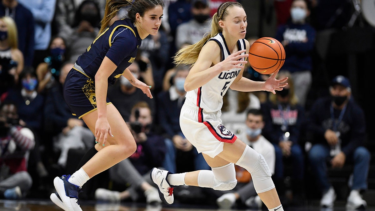 Connecticut's Paige Bueckers steals the ball from Notre Dame's Sonia Citron on Sunday, Dec. 5, 2021, in Storrs, Connecticut.