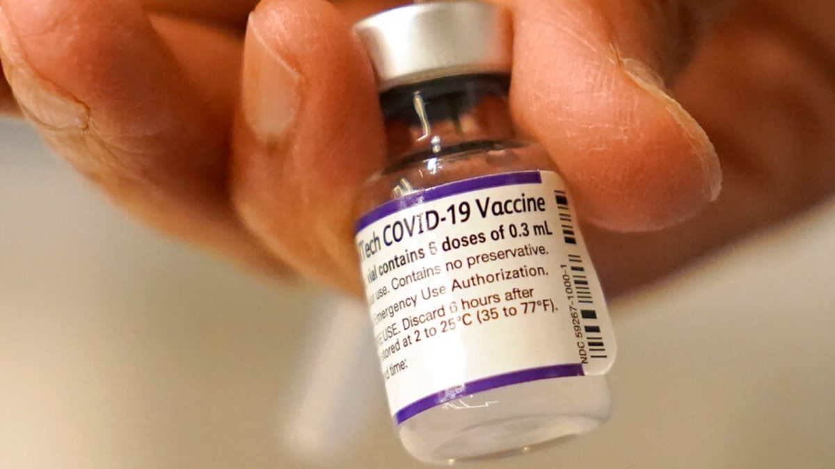 Dr. Manjul Shukla transfers Pfizer COVID-19 vaccine into a syringe, Thursday, Dec. 2, 2021, at a mobile vaccination clinic in Worcester, Mass. (AP Photo/Steven Senne, File) 