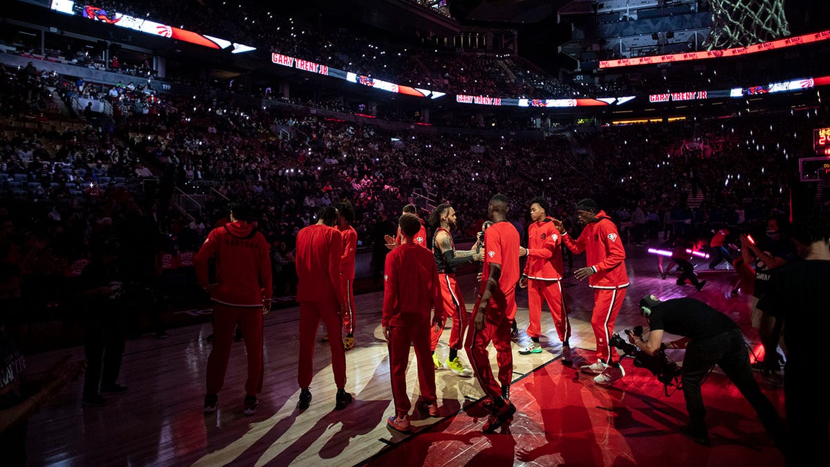 Toronto Raptors' Gary Trent Jr. is welcomed onto the court before the team's NBA basketball game against the New York Knicks on Friday, Dec. 10, 2021, in Toronto.