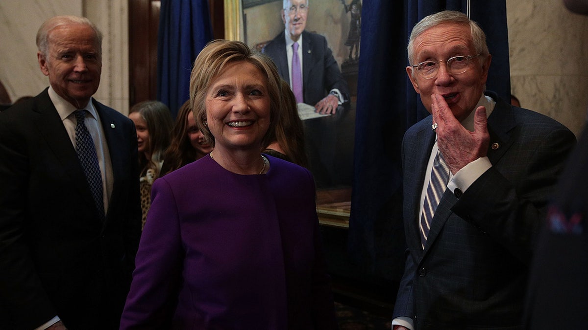 U.S. Senate Minority Leader Sen. Harry Reid (D-NV) (R), former Secretary of State Hillary Clinton (2nd L) and Vice President Joseph Biden (L)