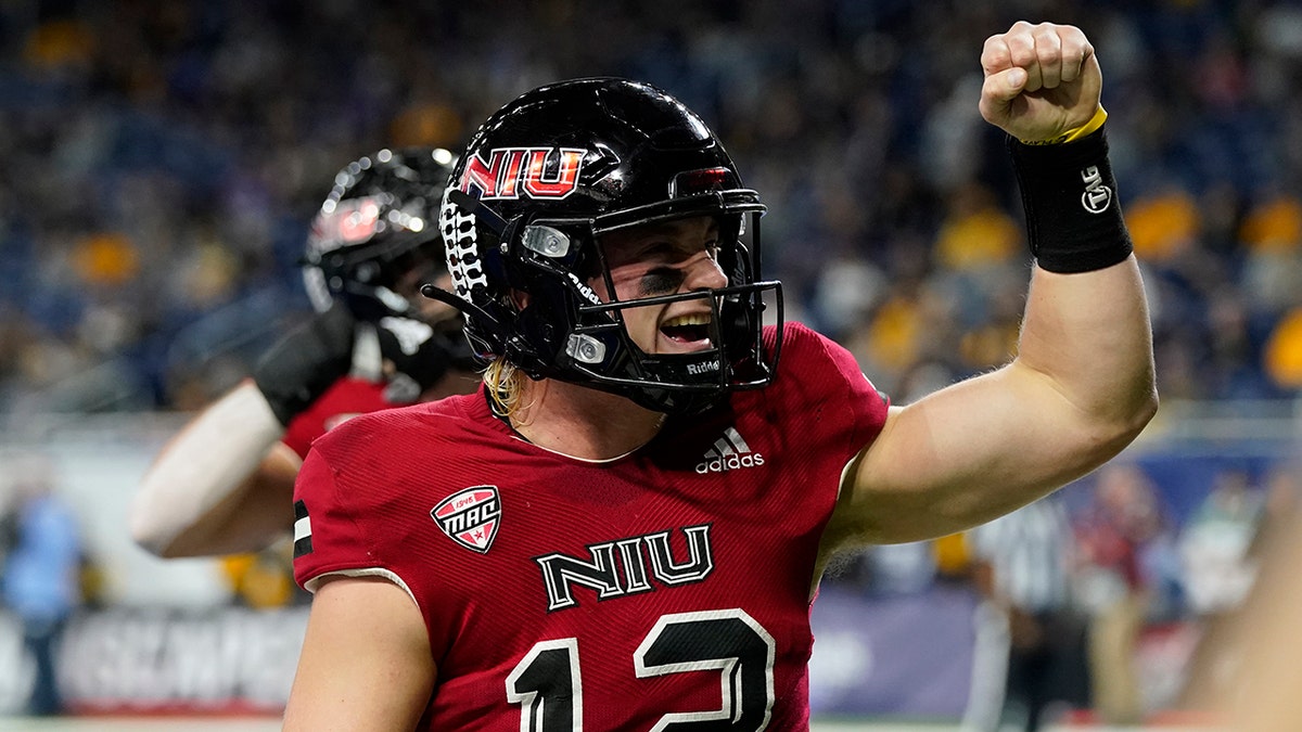 Northern Illinois quarterback Rocky Lombardi reacts toward fans after scoring on a 1-yard run during the first half against Kent State, Saturday, Dec. 4, 2021, in Detroit.