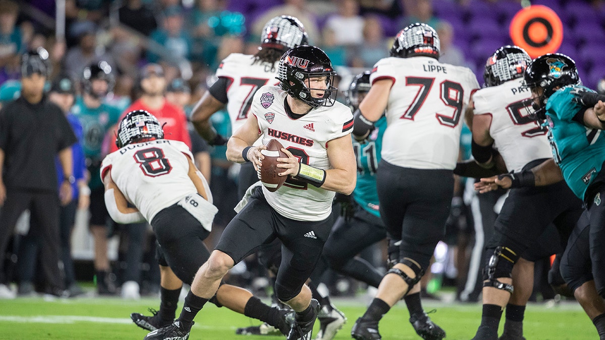 Coastal Carolina quarterback Bryce Carpenter (12) rolls out to throw the ball against Northern Illinois during the Cure Bowl in Orlando, Fla., Friday, Dec. 17, 2021.