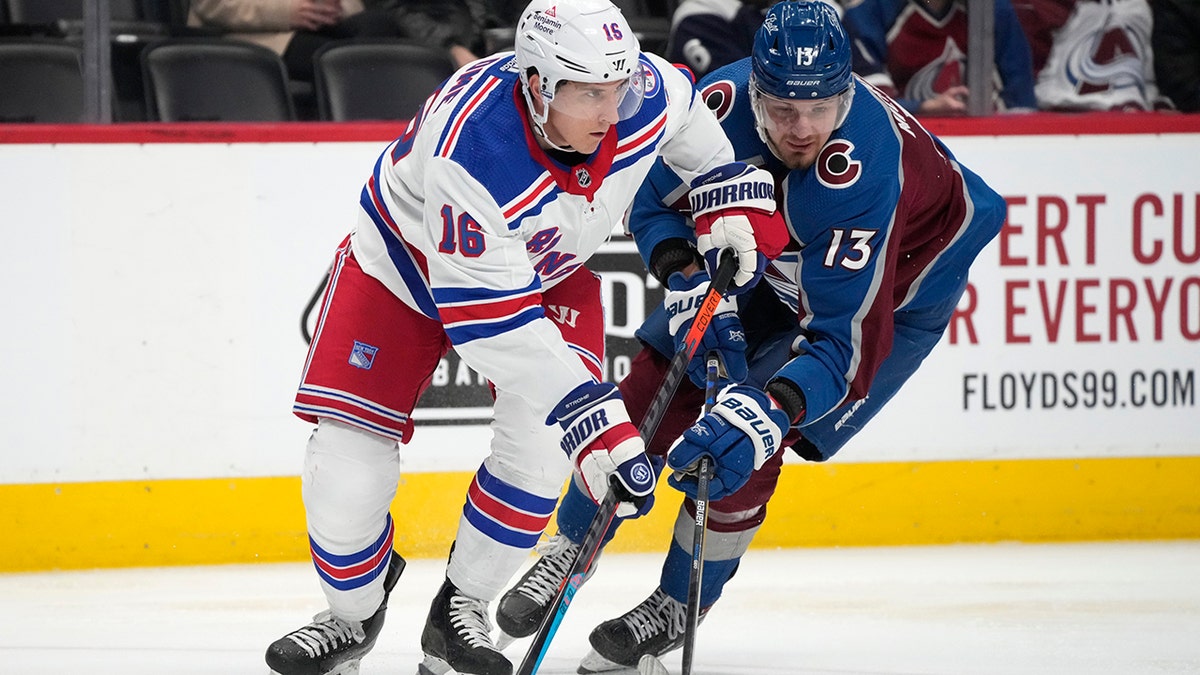 New York Rangers center Ryan Strome, left, passes the puck as Colorado Avalanche right wing Valeri Nichushkin defends in the second period of an NHL hockey game Tuesday, Dec. 14, 2021, in Denver.
