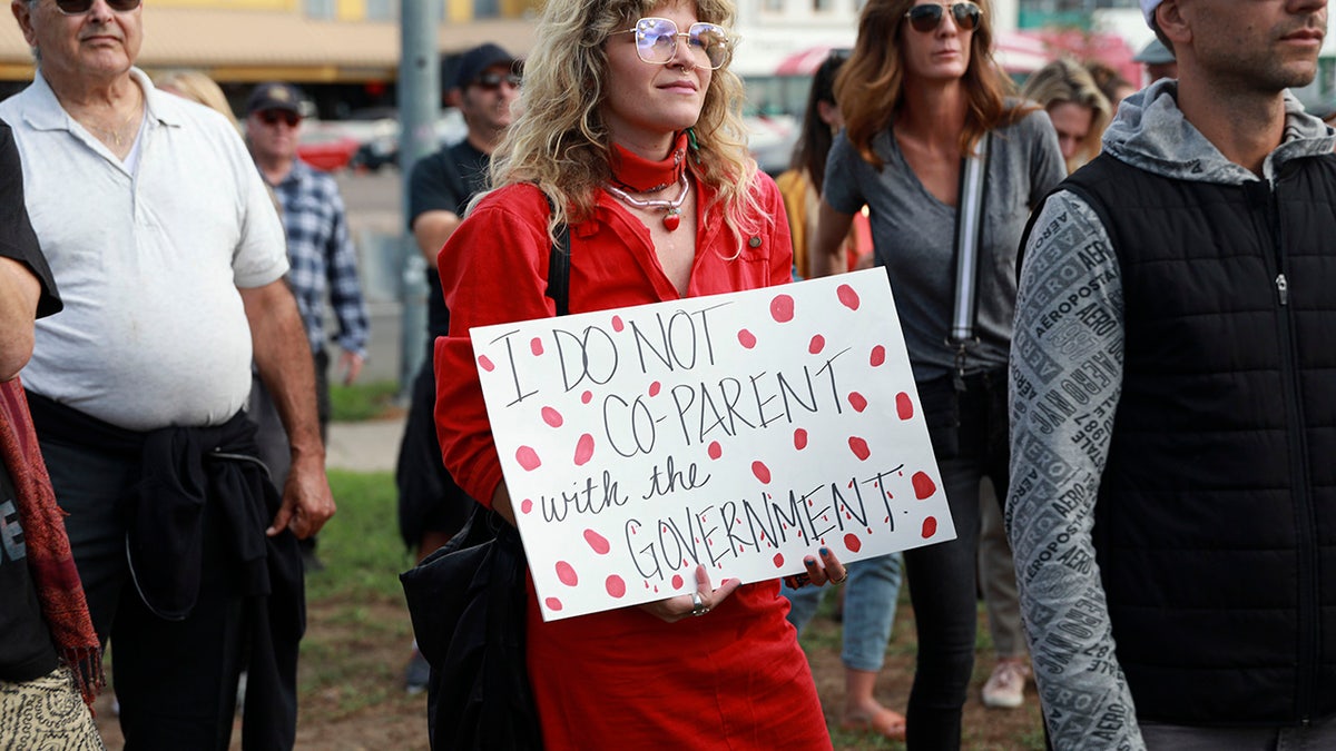 Vaccine protester with sign