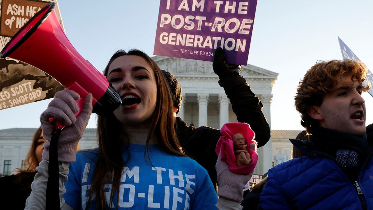 An anti-abortion demonstrator protests in front of the Supreme Court building