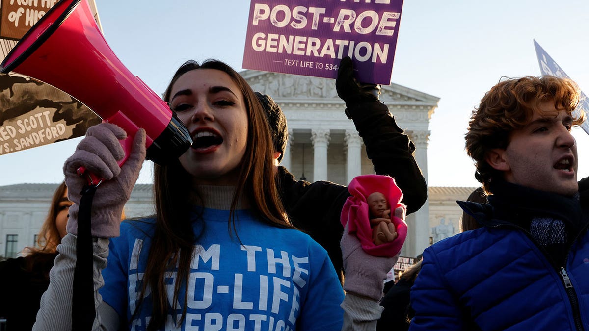 An anti-abortion demonstrator protests in front of the Supreme Court building