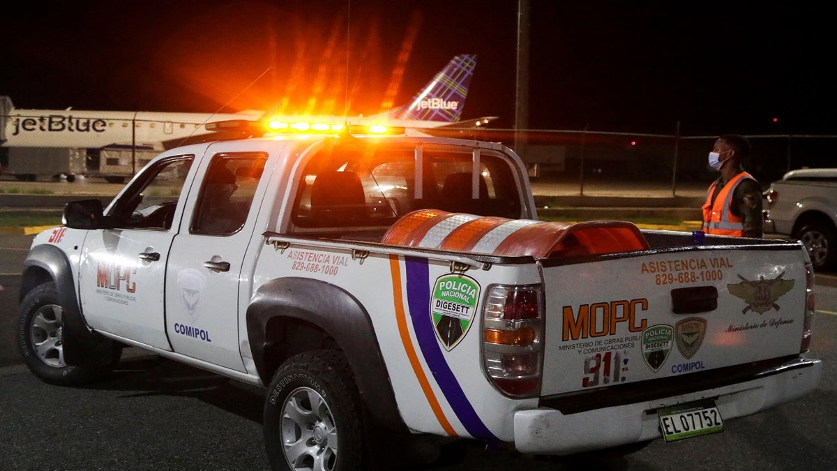 Police members of roadside assistance stand outside the Las Americas International Airport  on Wednesday. 