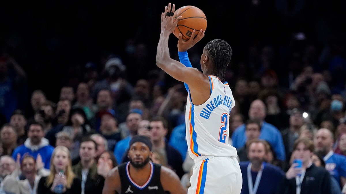 Oklahoma City Thunder guard Shai Gilgeous-Alexander (2) shoots a game-winning 3-point shot in front of Los Angeles Clippers forward Justise Winslow (20) at the end of an NBA basketball game, Saturday, Dec. 18, 2021, in Oklahoma City.