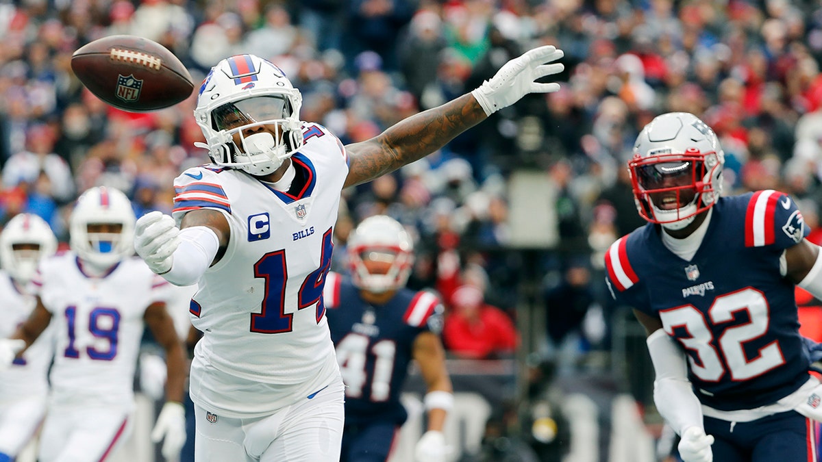 Buffalo Bills wide receiver Stefon Diggs (14) misses a pass against New England Patriots free safety Devin McCourty (32) during the first half Sunday, Dec. 26, 2021, in Foxborough, Mass.