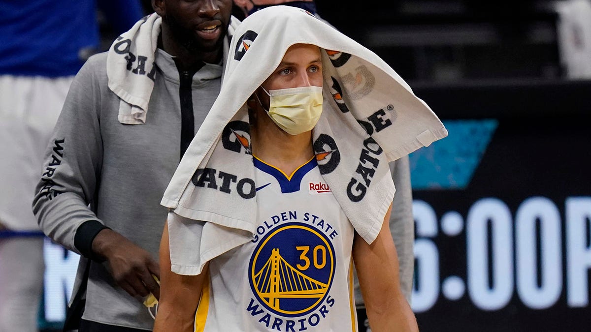 FILE -Golden State Warriors guard Stephen Curry (30) wears a face mask to protect against the spread of COVID-19 during the second half of an NBA basketball game against the San Antonio Spurs in San Antonio, Tuesday, Feb. 9, 2021. 