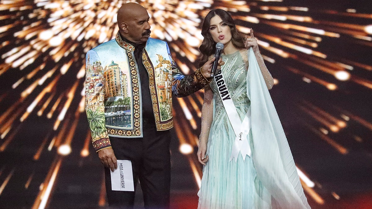 Paraguay's Nadia Ferreira, right, answers the final question as host Steve Harvey looks on during the 70th Miss Universe pageant.