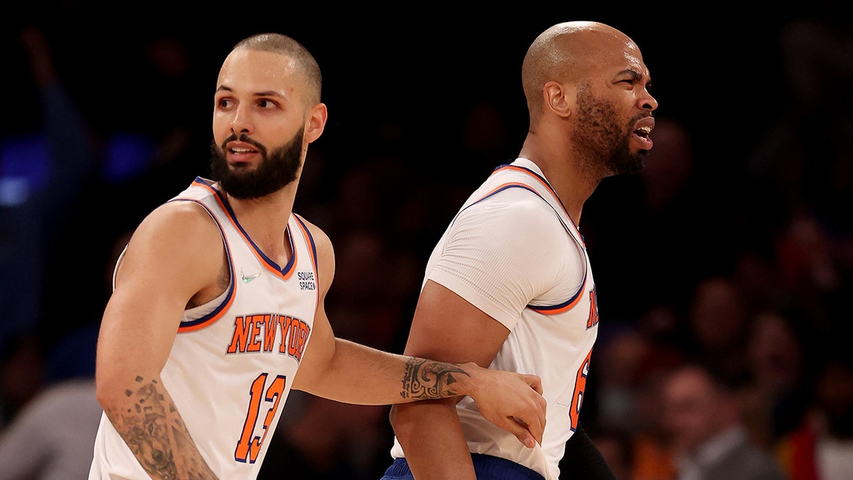 Taj Gibson (67) of the New York Knicks is held back by teammate Evan Fournier (13) after Gibson is called for double technical fouls and is ejected from the game in the first half against the Chicago Bulls at Madison Square Garden Dec. 2, 2021 in New York City.