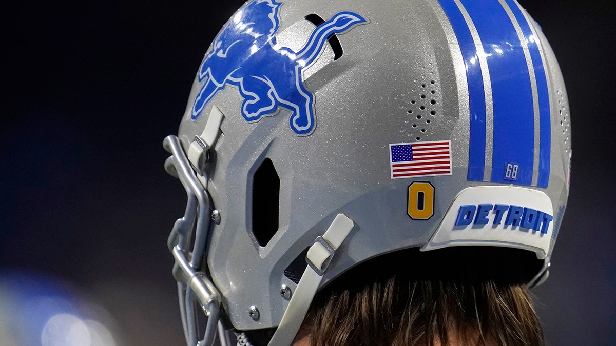 Detroit Lions offensive tackle Taylor Decker sports an Oxford decal, honoring the students killed at the high school this week, during pregame of an NFL football game against the Minnesota Vikings, Sunday, Dec. 5, 2021, in Detroit.