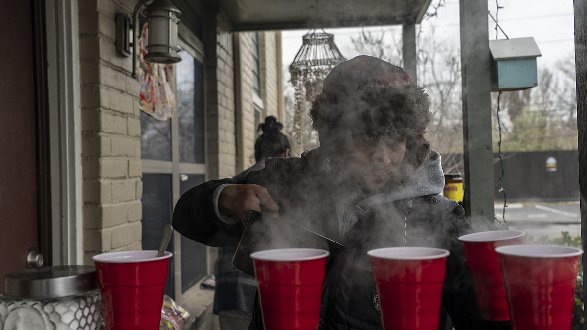 Victor Zelaya makes hot coffee for his roommates during a power outage caused by a winter storm on Feb. 16 in Houston, Texas.