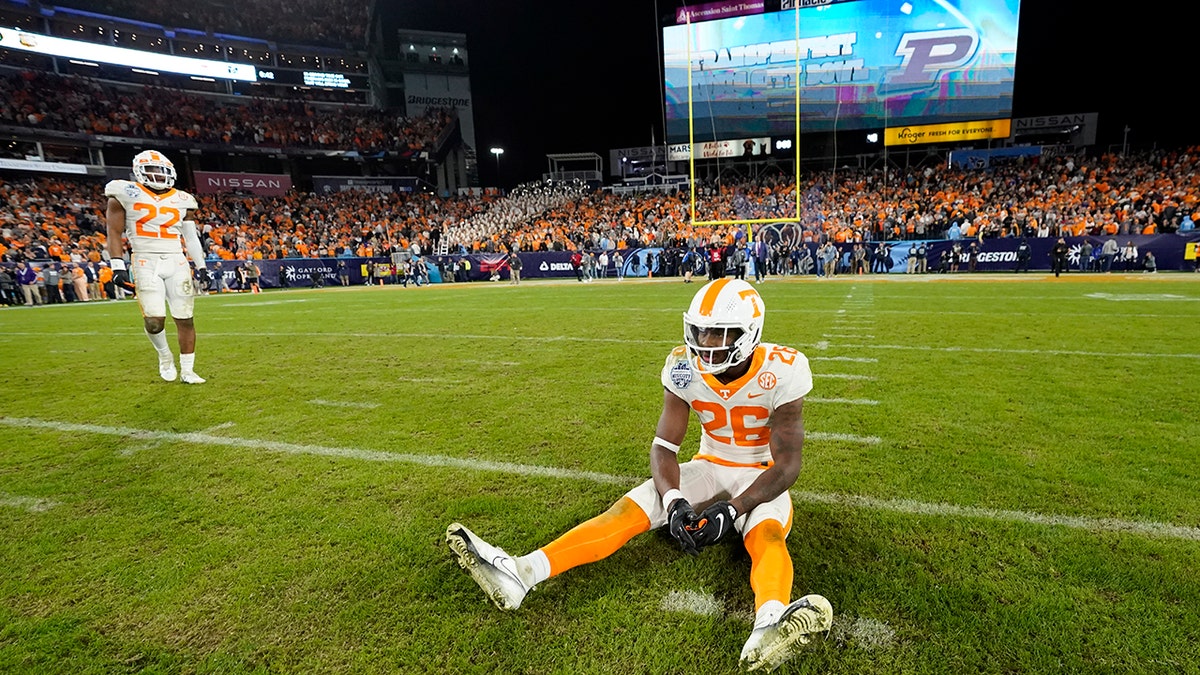 Tennessee defensive back Theo Jackson (26) sits on the field after Purdue kicked a field goal in overtime to win the Music City Bowl NCAA college football game Thursday, Dec. 30, 2021, in Nashville, Tennessee. 