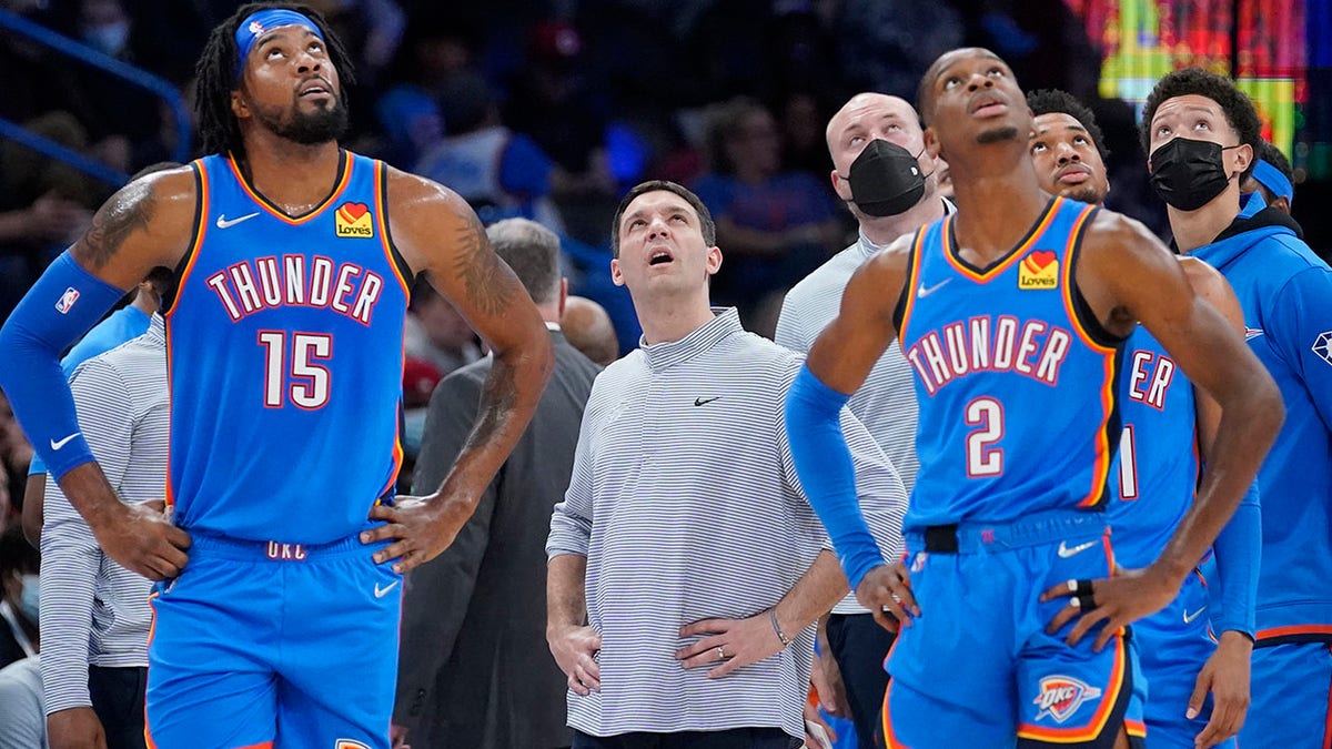 Oklahoma City center Derrick Favors (15), head coach Mark Daigneault and guard Shai Gilgeous-Alexander (2) looks up at the scoreboard during a time out in the second half of an NBA basketball game Wednesday, Dec. 15, 2021, in Oklahoma City.