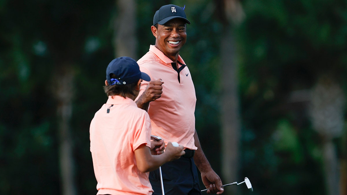 Tiger Woods reacts with his son Charlie Woods on the 16th green during the first round of the PNC Championship golf tournament Saturday, Dec. 18, 2021, in Orlando, Fla.