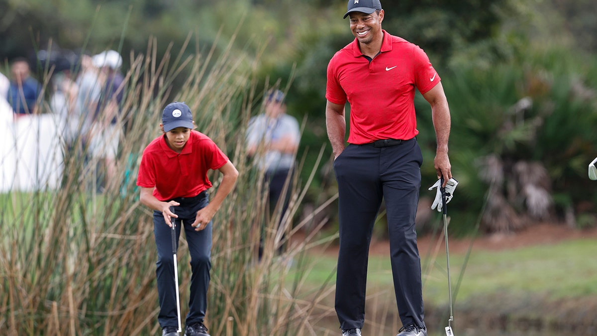 Tiger Woods smiles while walking on the second green during the second round of the PNC Championship golf tournament Sunday, Dec. 19, 2021, in Orlando, Fla.