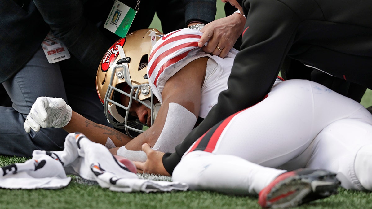 San Francisco 49ers running back Trenton Cannon is tended to after an injury