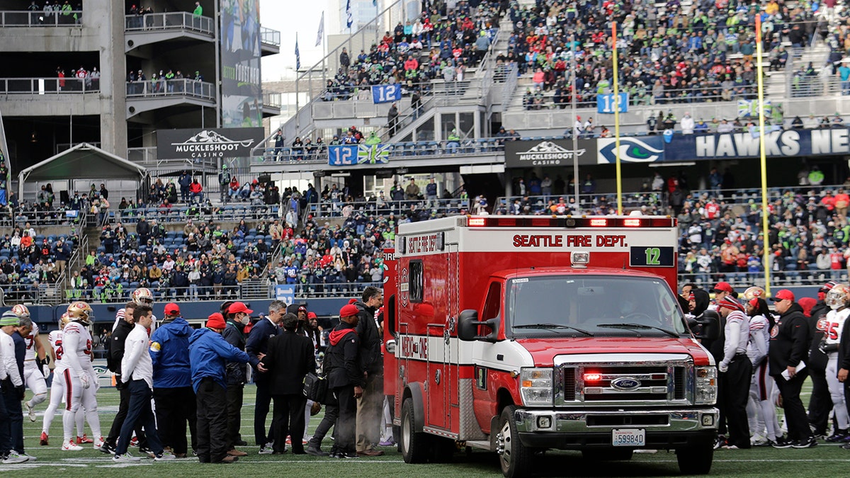 San Francisco 49ers running back Trenton Cannon is loaded into an ambulance after an injury 