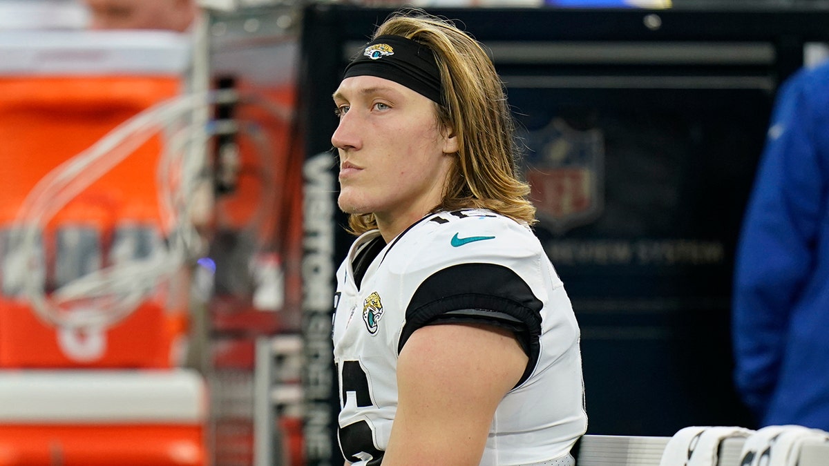 Jacksonville Jaguars quarterback Trevor Lawrence sits on the bench in the closing minutes of a loss to the Los Angeles Rams during the second half of an NFL football game Sunday, Dec. 5, 2021, in Inglewood, Calif.