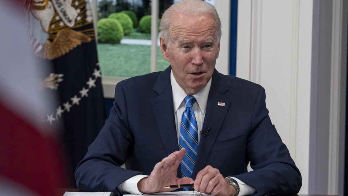 U.S. President Joe Biden speaks while joining the White House Covid-19 Response Team's call with the National Governors Association discussing the Omicron variant in the Eisenhower Executive Office Building in Washington, D.C., U.S., on Monday, Dec. 27, 2021. Biden's medical adviser said a domestic travel vaccination rule should be considered as the omicron variant fuels record Covid-19 case loads in some states and holiday travel continues to be disrupted around the U.S. Photographer: Ken Cedeno/UPI/Bloomberg via Getty Images