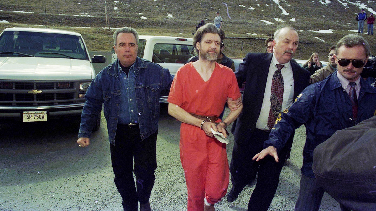 Theodore "Ted" Kaczynski is guided to his arraignment in Helena, Montana, on April 4, 1996, following his arrest in connection with the "Unabomber" investigation.